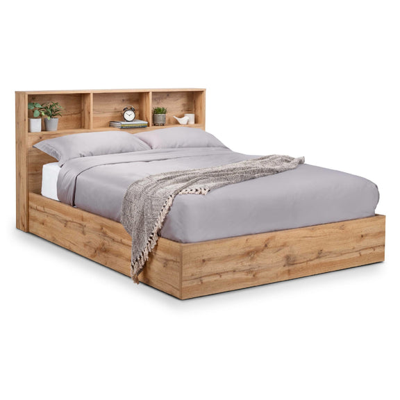 Wooden bed with bookshelf headboard and gray bedding on a white background
