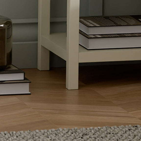 Close-up of a wooden floor with a bookshelf in the background