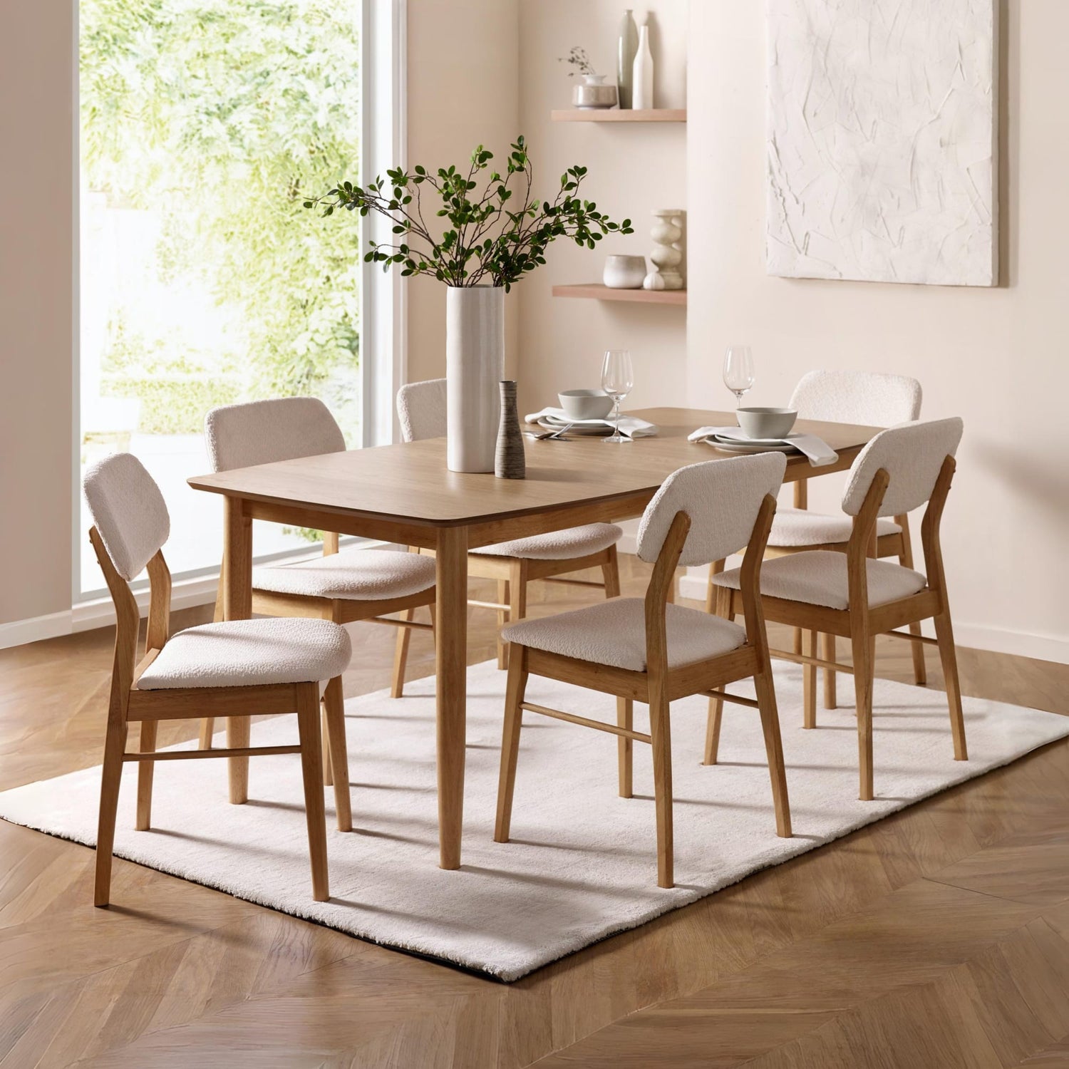 Dining room with wooden table and chairs on a white rug