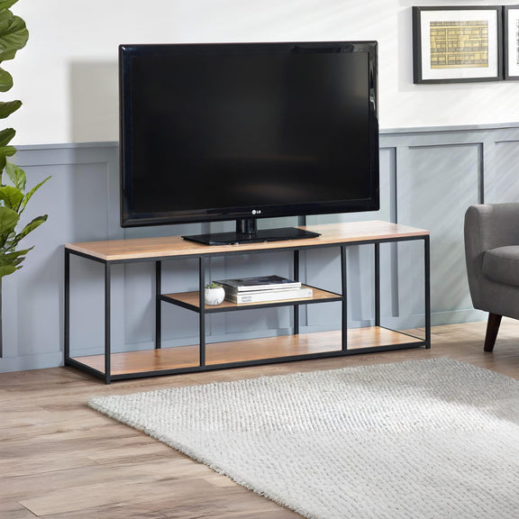 TV on a wooden stand in a living room setting with a plant and sofa.