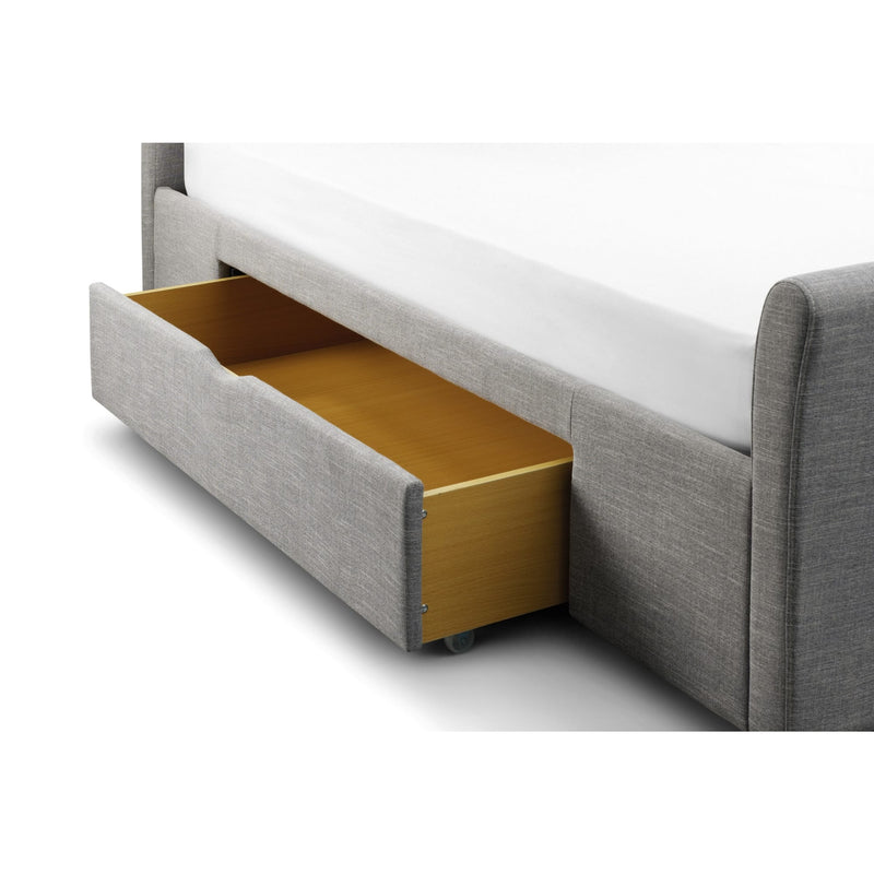 Gray upholstered bed with a wooden drawer open on a white background