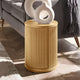 Wooden side table with a white decorative vase in a living room setting
