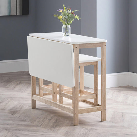 Wooden dining table with white seat and backrest in a room with gray walls and wooden floor.