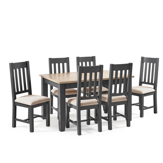 Dining table set with six chairs on a white background