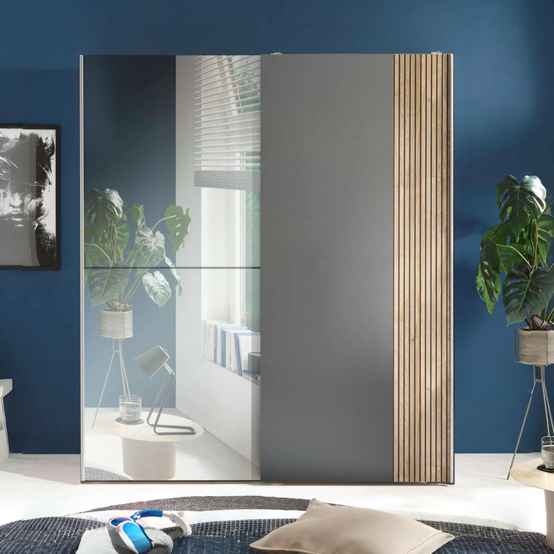 Modern interior design with a large mirror reflecting a room, blue walls, and decorative elements.