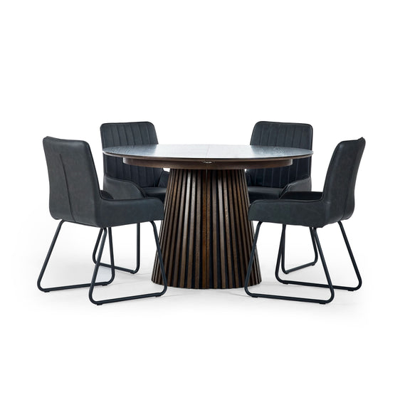 Round dining table with four black chairs on a white background