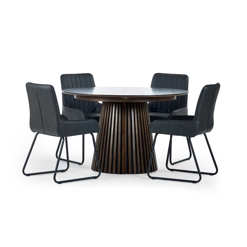 Round dining table with four black chairs on a white background