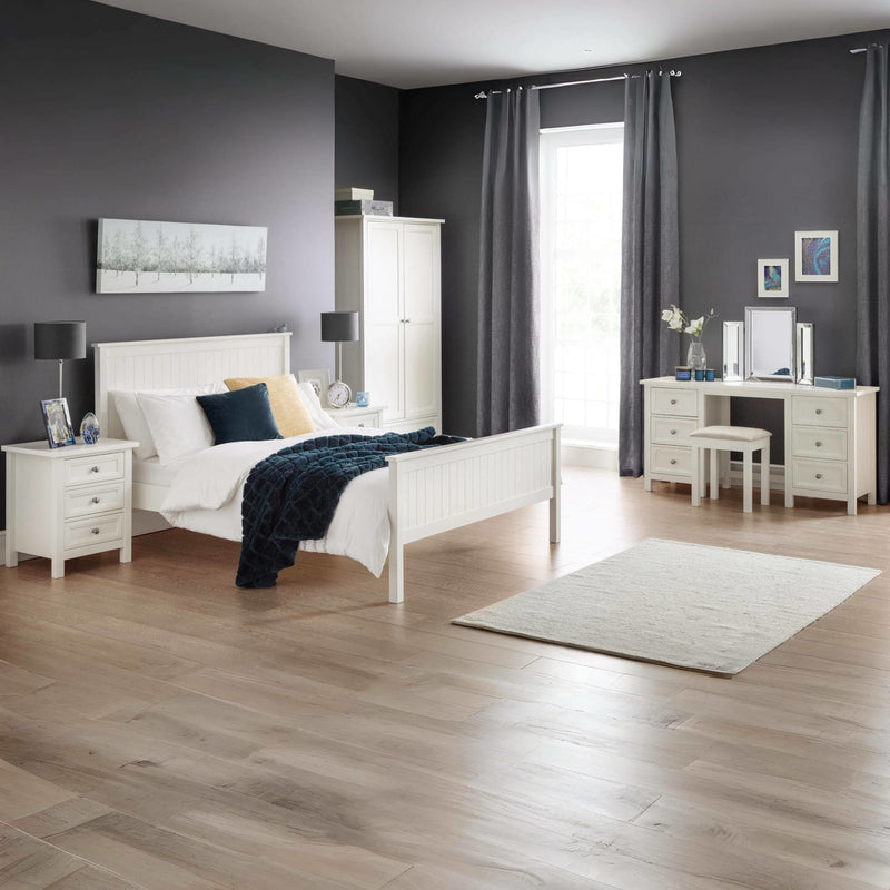 Modern bedroom with white furniture, gray walls, and wooden flooring.