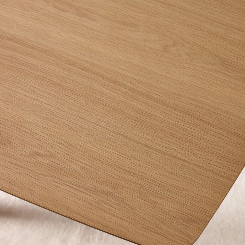 Close-up of a wooden surface with a soft beige fabric underneath