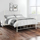 White metal bed with gray bedding in a bedroom setting