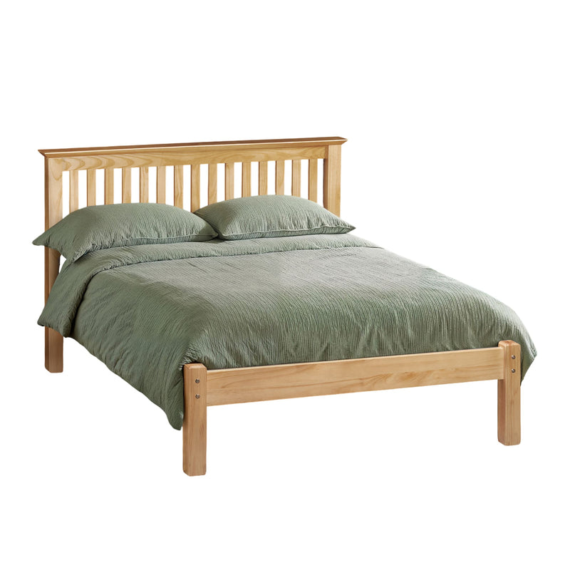 Wooden bed with green bedding on a white background