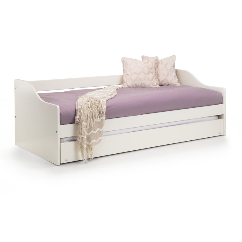 White daybed with purple mattress, beige blanket, and pillows on a white background