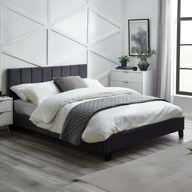 Modern bedroom with a bed, nightstands, and decor elements.