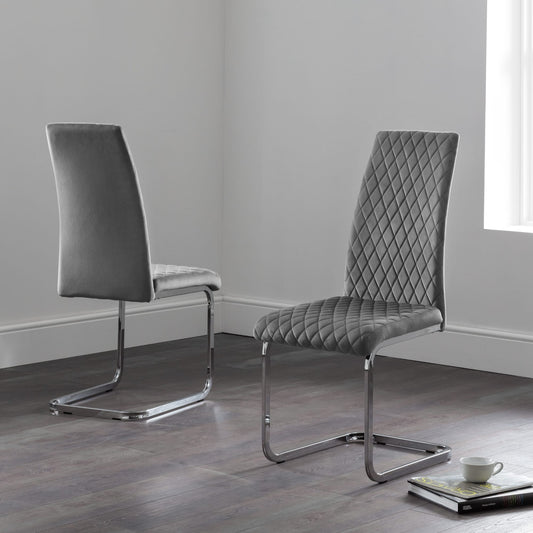 Two gray chairs with quilted design on a wooden floor.