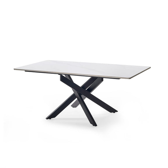 Modern dining table with a white top and black metal legs on a white background