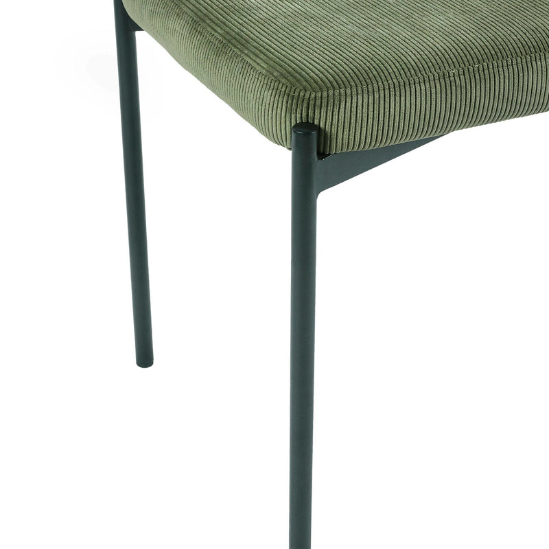 Green chair with black metal legs on a white background