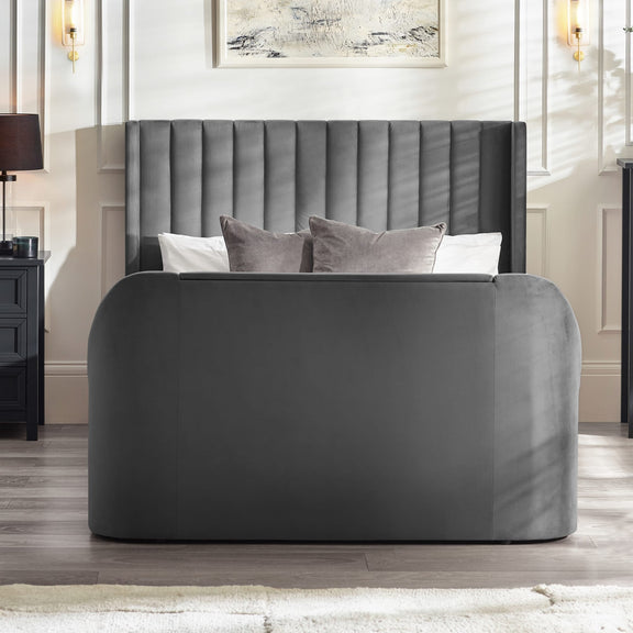 Gray upholstered bed with tufted headboard in a bedroom setting