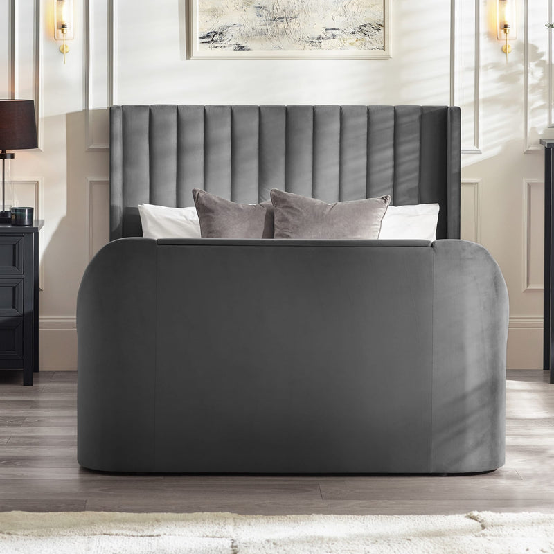 Gray upholstered bed with tufted headboard in a bedroom setting