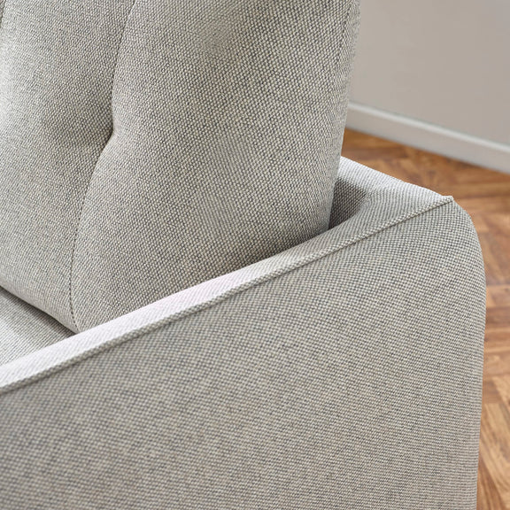 Gray upholstered chair with a wooden floor in the background