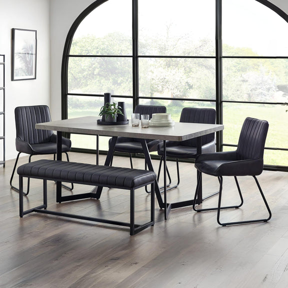 Dining room set with table, chairs, and bench in a modern interior.