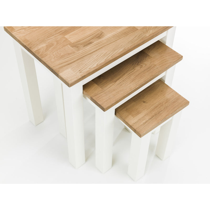 Wooden table with three matching stools on a white background