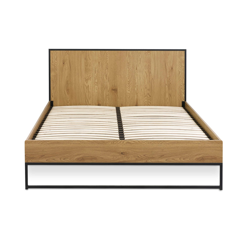 Wooden bed frame with white mattress on a white background