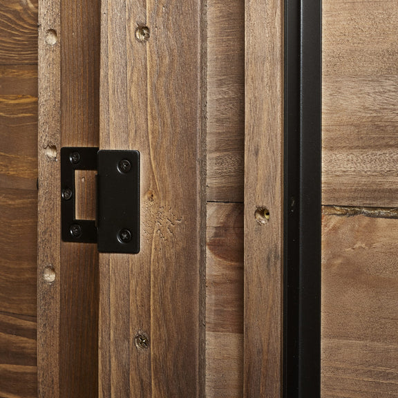 Close-up of a wooden door with a black metal hinge.
