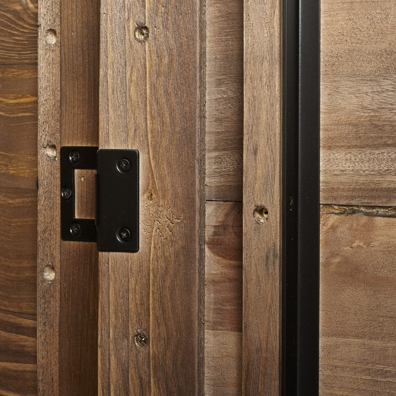 Close-up of a wooden door with a black metal hinge.