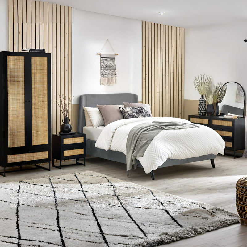 Modern bedroom with a bed, nightstands, and decorative elements.
