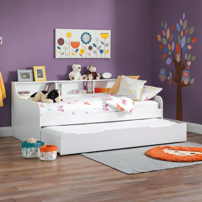 Children's bedroom with a white bed, toys, and decorative elements on a purple wall.