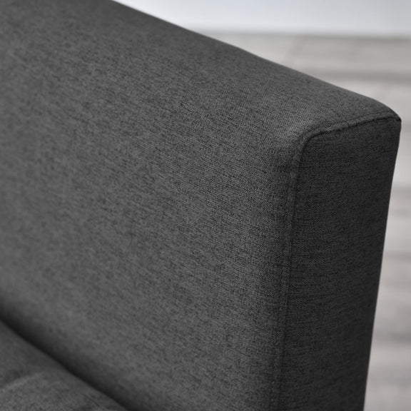 Gray fabric corner of a sofa with a neutral background