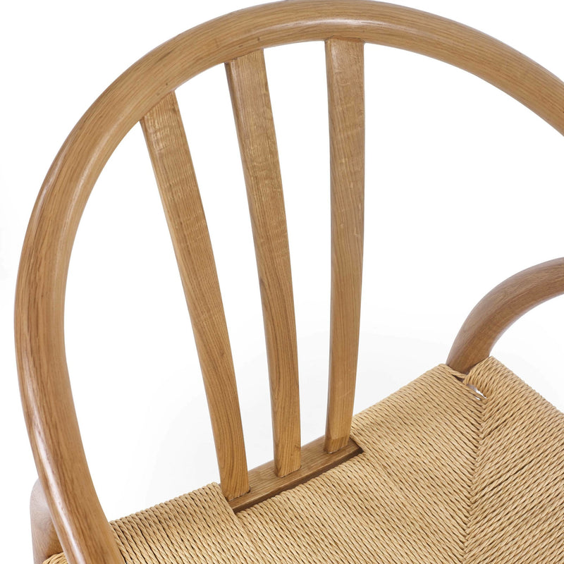 Close-up of a wooden chair with woven seat on a white background