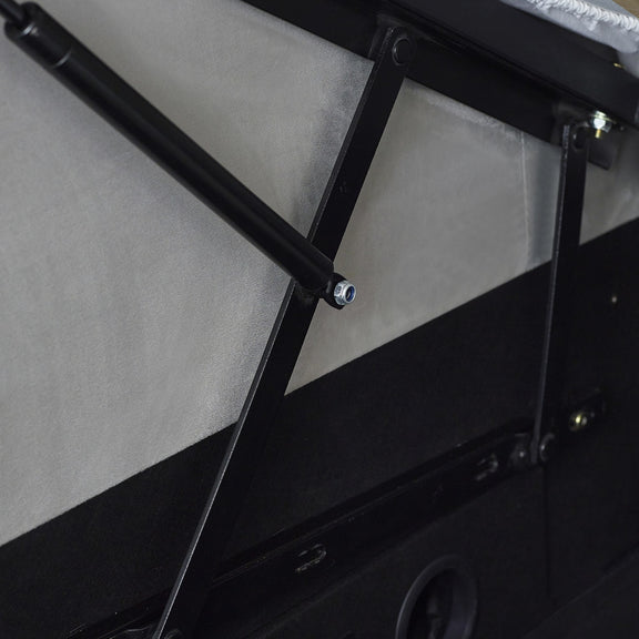 Close-up of a black metal rod and bracket on a vehicle's side panel.