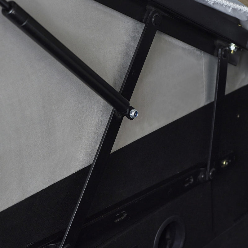 Close-up of a black metal rod and bracket on a vehicle's side panel.