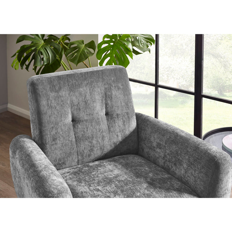 Gray armchair in a room with large windows and a plant