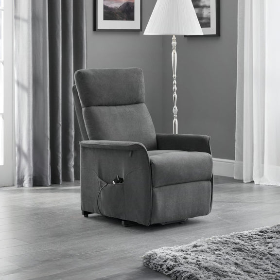 Gray recliner chair in a living room setting with curtains and a lamp.