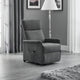 Gray recliner chair in a living room setting with curtains and a lamp.