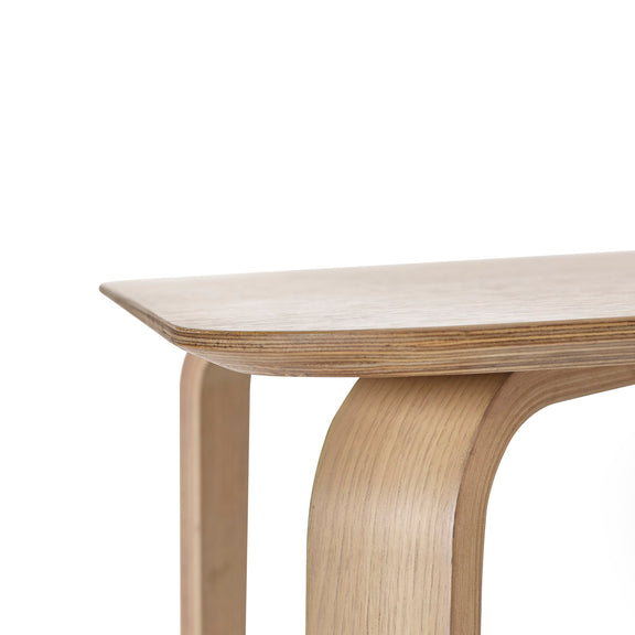 Wooden table with a curved leg design on a white background