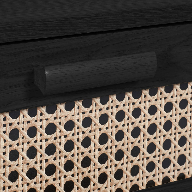 Close-up of woven rattan drawer front on black bedside table