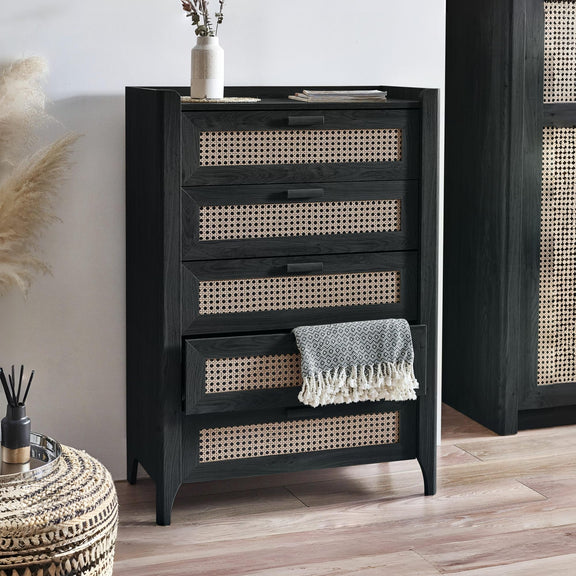 Black dresser with wicker drawers in a room setting