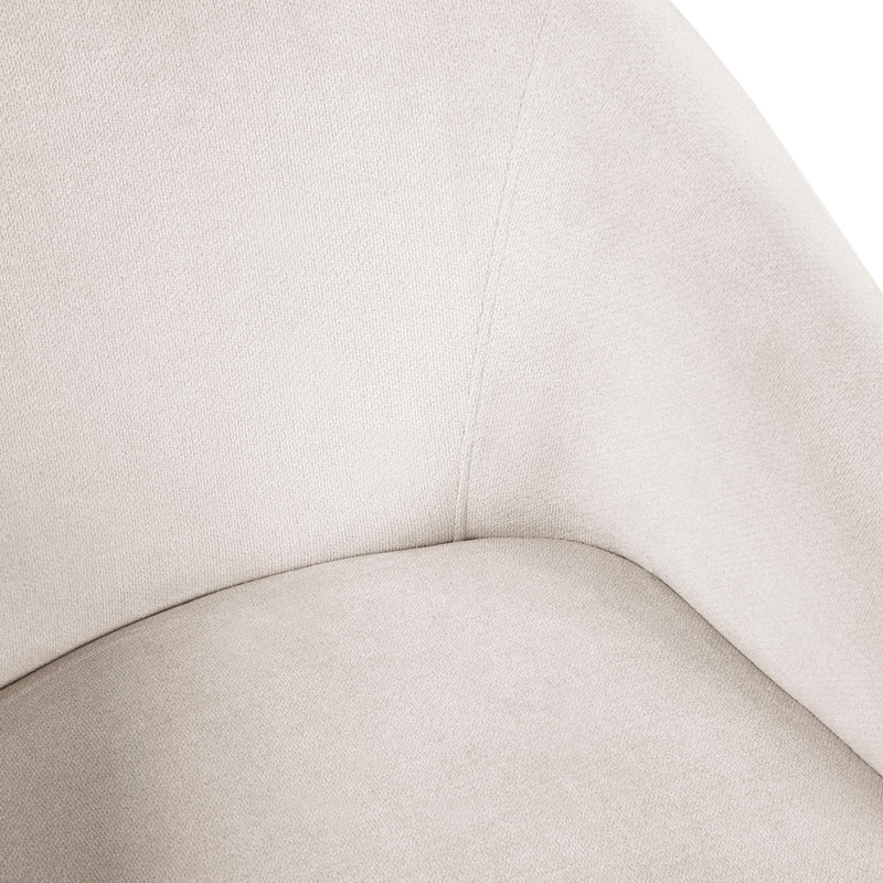 Close-up of a beige upholstered chair with a focus on the fabric texture.