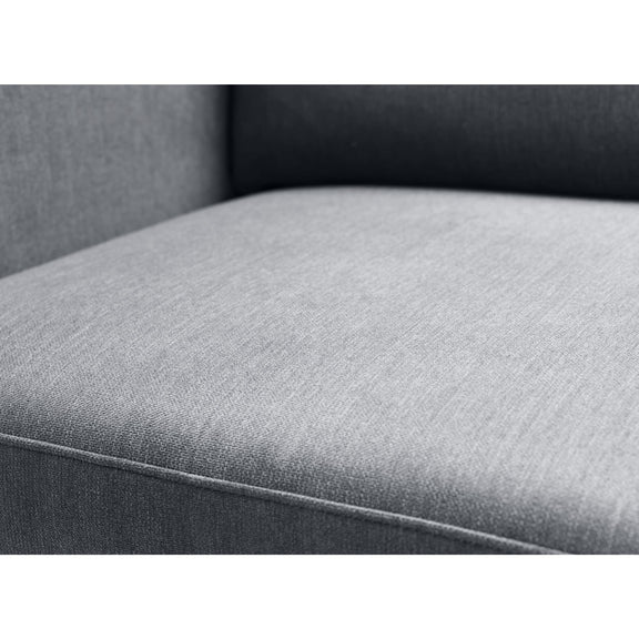 Close-up of a gray upholstered chair seat with a white background