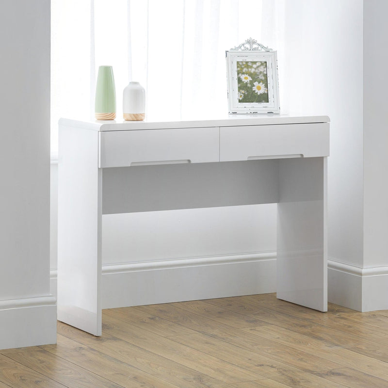 White console table with two drawers and a small mirror on a wooden floor.
