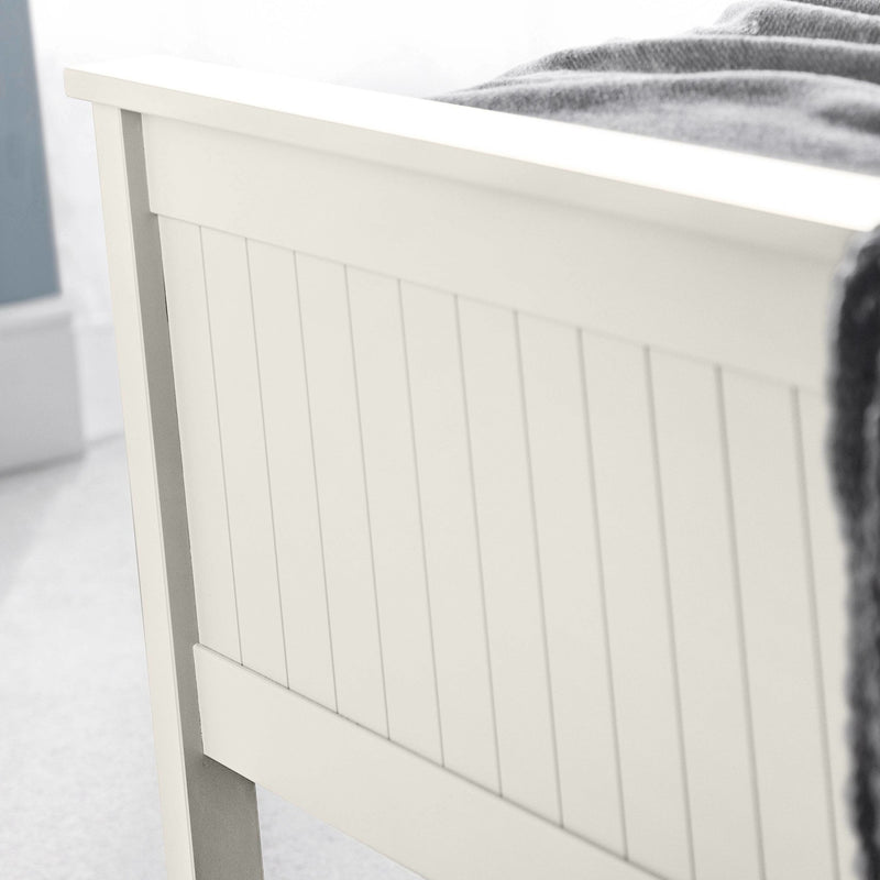 White wooden headboard with a blurred background