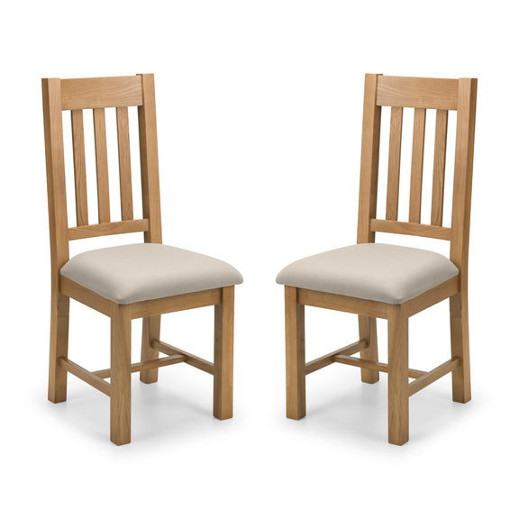 Two wooden chairs with beige cushioned seats on a white background