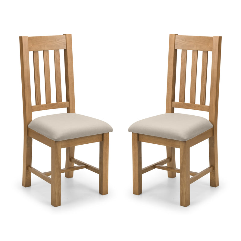 Two wooden chairs with beige cushioned seats on a white background