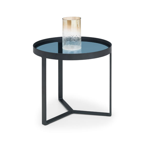 Small round table with a blue glass top and black metal frame on a white background