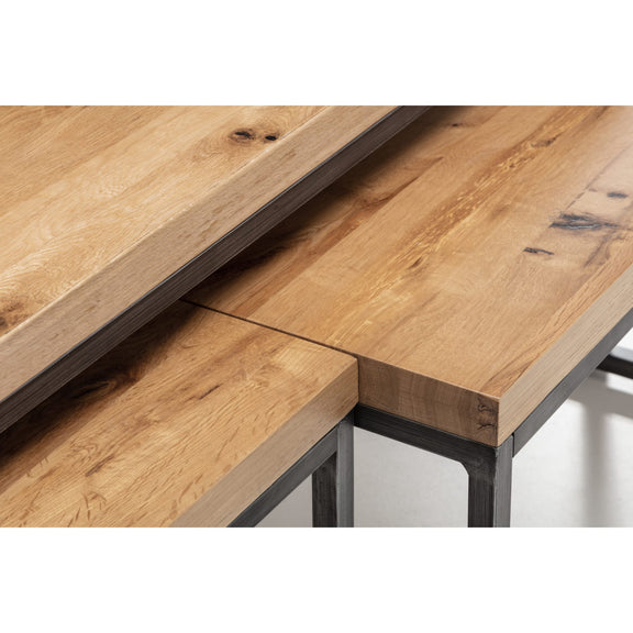 Close-up of a wooden desk with metal legs on a white background
