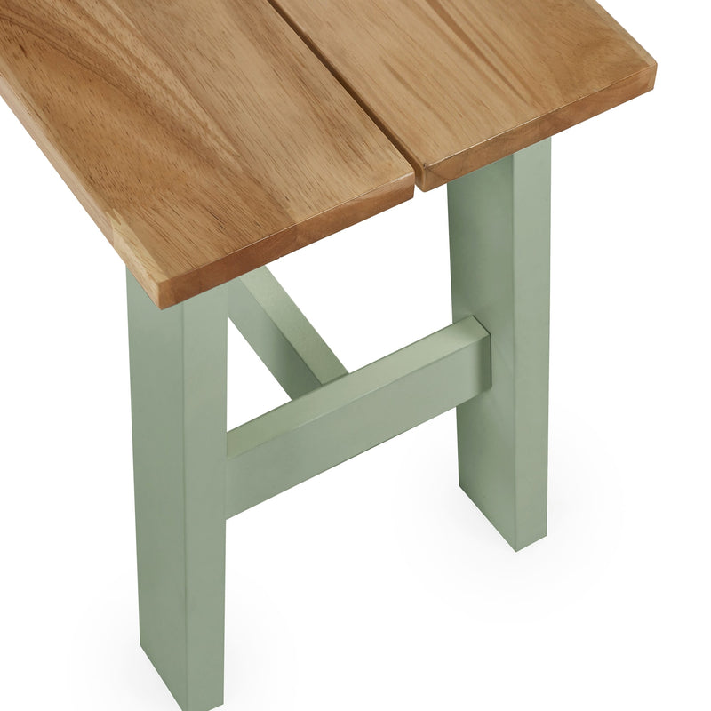 Wooden table with green legs on a white background