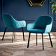 Two teal chairs with black legs on a wooden floor against a blue wall.